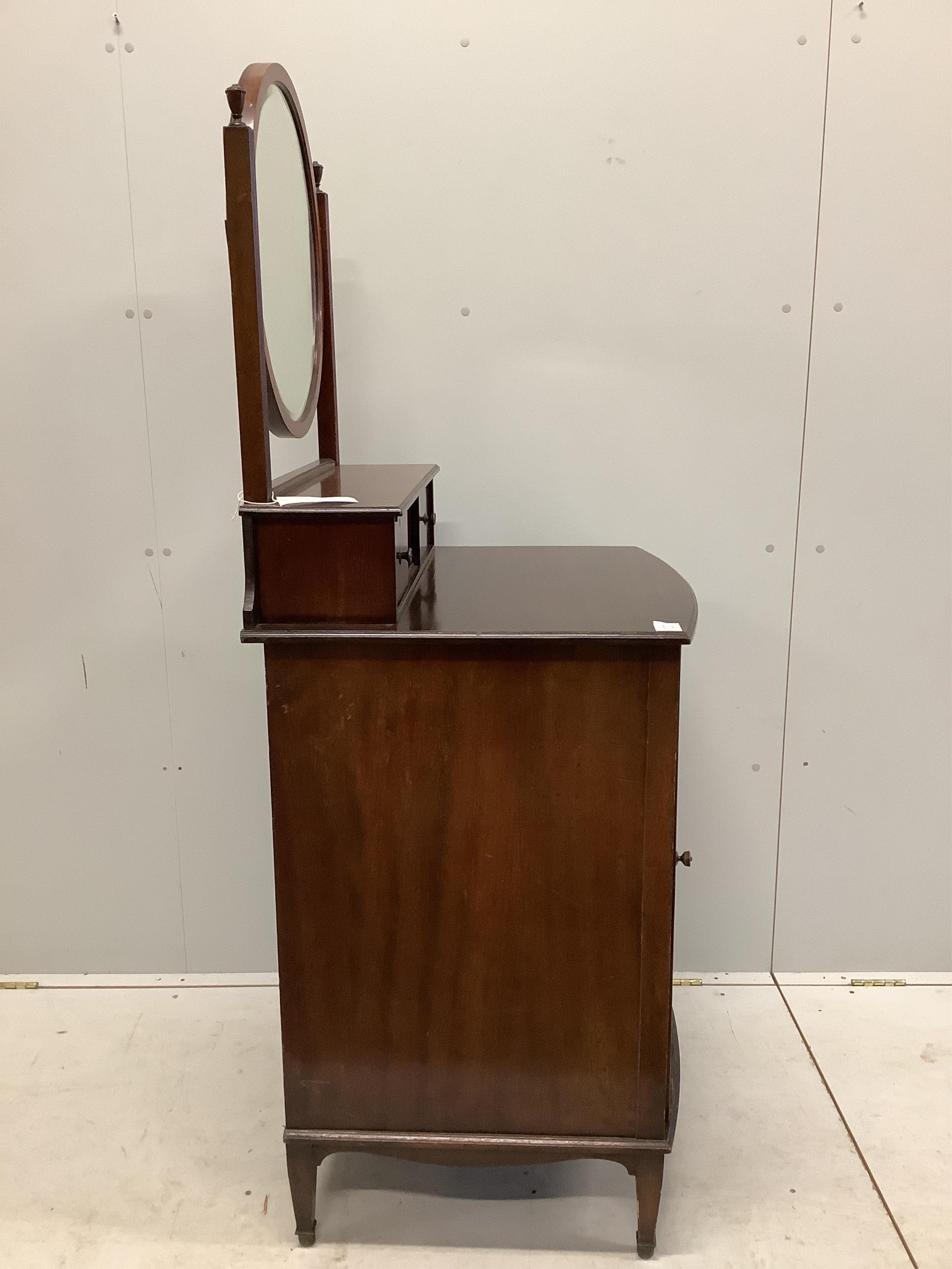 An early 20th century mahogany bowfront dressing chest, with bevelled plate circular mirror, and panelled cupboard base, width 68cm, depth 58cm, height 158cm. Condition - fair